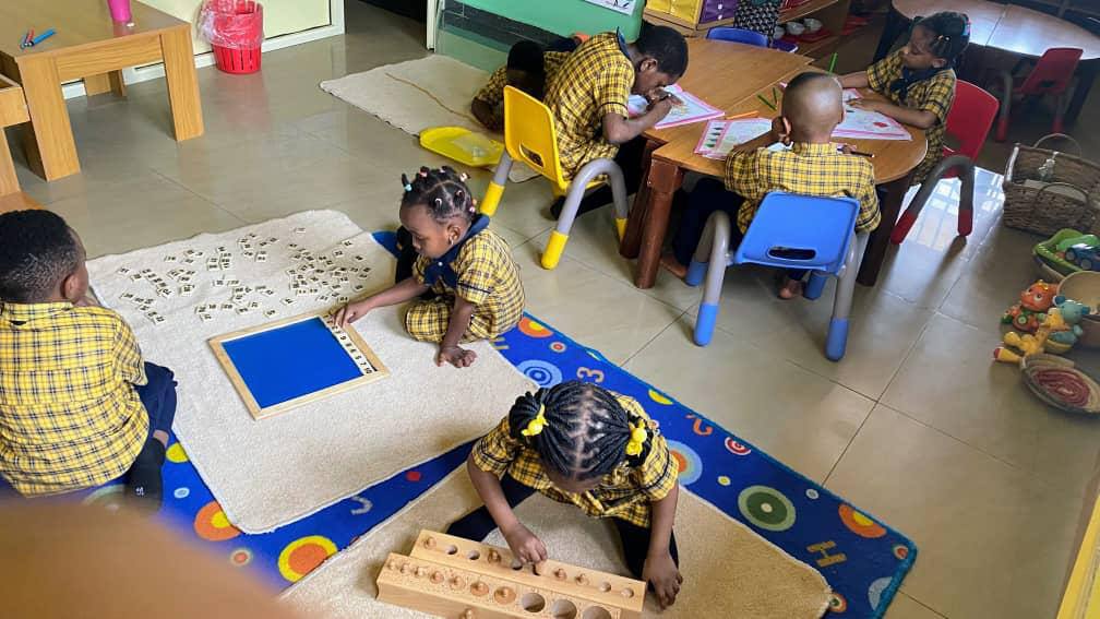 Pupil writing numbers on a classroom whiteboard